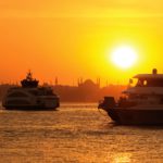 White and black boat at sunset