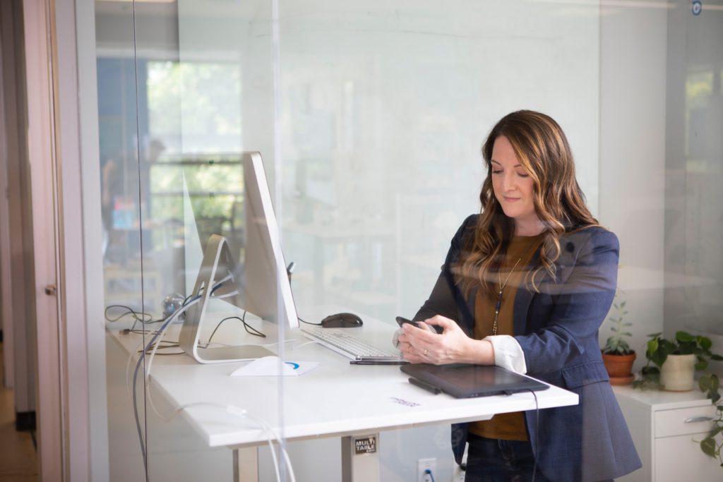 Woman in leather jacket using MacBook Air