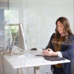 Woman in leather jacket using MacBook Air