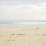 white sand and rippling body of water